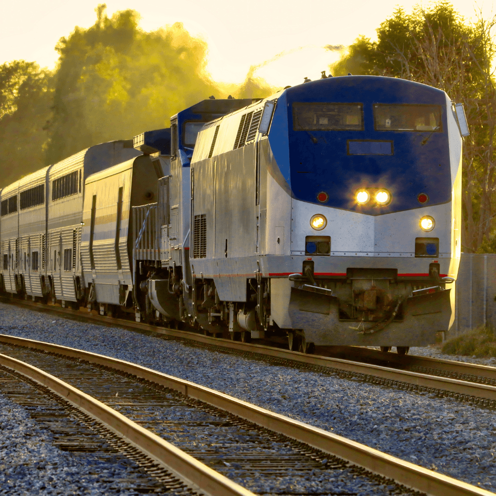 A train travels along curved tracks at sunset.